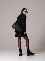 Model posing in stylish clothing and bag © Streetstylephoto