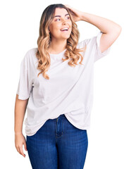 Obraz premium Young caucasian woman wearing casual clothes smiling confident touching hair with hand up gesture, posing attractive and fashionable