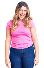 Obraz premium Young caucasian woman wearing sportswear winking looking at the camera with sexy expression, cheerful and happy face.