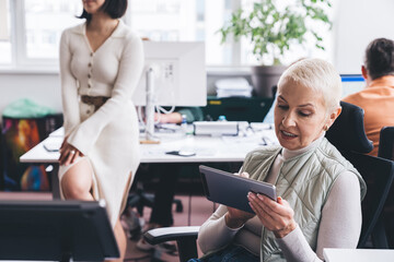 Businesswoman using tablet in modern workspace