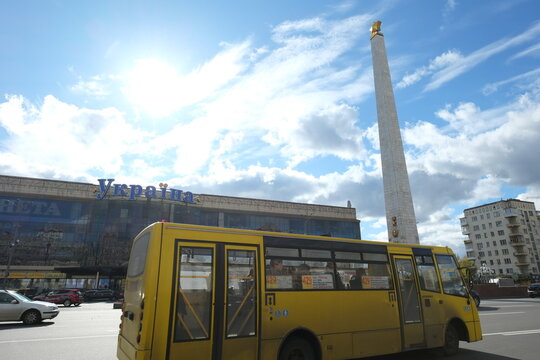 Kyiv, Ukraine - October the 15th, 2017: A view of some buildings and a yellow bus in Kiyv at Victory square.