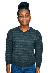 Young african american woman wearing casual clothes relaxed with serious expression on face. simple...