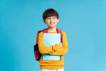 Portrait of Asian school boy born on a blue background