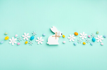 Easter Eggs with Sweets and Spring Flowers on Blue Background