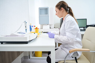 Hematologist workplace surrounded by special equipment for blood testing