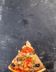 Traditional Italian Pizza with mozzarella, tomatoes and salami over black background, copy space....