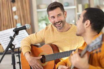 guitar teacher teaching his male client