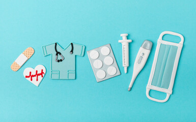 National Day of Doctors. Modern stethoscope, gift box and gingerbread in the form of medical supplies on a blue background. .Gingerbread in the form of a thermometer, a medical mask, a pill, a patch.