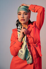 portrait of a woman in an orange dress and a headscarf