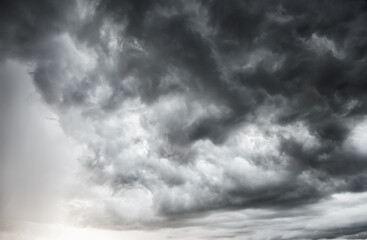 Obraz premium dark clouds make sky in black. Heavy rain thunderstorm. Pattern of clouds overcast predict tornado, Hurricane or thunderstorm and rainy. Dark sky cloudy have storm and lightning thunderbolt.