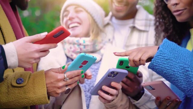 Group of young teenagers friends using cell phones and walking in the city. Concept of community millennial people addicted to technology. Social Media communication generation Z