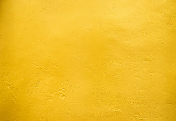 Artificial Gold background and texture on cement make from color paint for look like real gold. Gold foil leaf dirty abstract background texture distress scratch and gradients shadow in Gold glitter