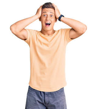 Young handsome man wearing casual clothes crazy and scared with hands on head, afraid and surprised of shock with open mouth