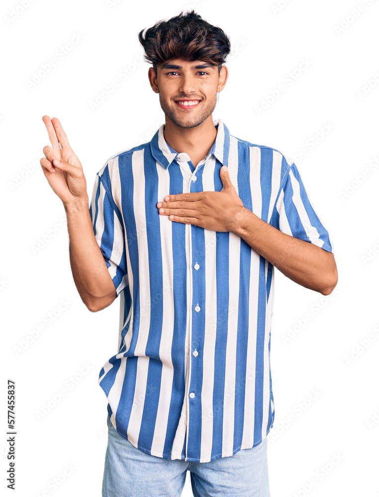 Sticker young hispanic man wearing casual clothes smiling swearing with hand on chest and fingers up, making