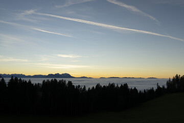 Fototapeta premium Sunset in the mountains above a sea of fog