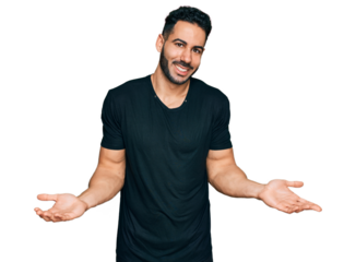 Hispanic man with beard wearing casual black t shirt clueless and confused expression with arms and hands raised. doubt concept.