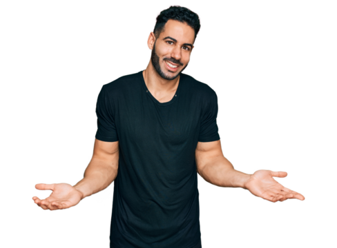 Hispanic man with beard wearing casual black t shirt clueless and confused expression with arms and hands raised. doubt concept.