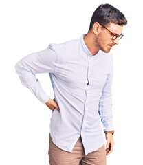 Fototapeta premium Handsome young man with bear wearing elegant business shirt and glasses suffering of backache, touching back with hand, muscular pain