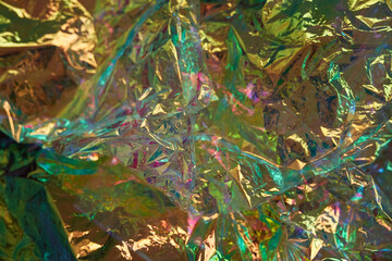 Iridescent texture. Holographic background. A hologram of gradient neon color. Foil effect. Rainbow graphics. Chrome-plated space design for prints. High quality photo