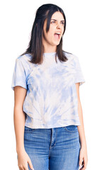 Fototapeta premium Young beautiful girl wearing casual t shirt angry and mad screaming frustrated and furious, shouting with anger. rage and aggressive concept.