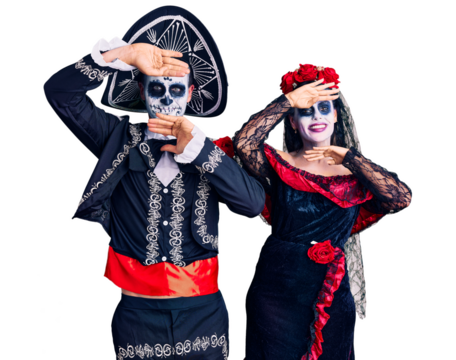 Young couple wearing mexican day of the dead costume over background smiling cheerful playing peek a boo with hands showing face. surprised and exited - Powered by Adobe