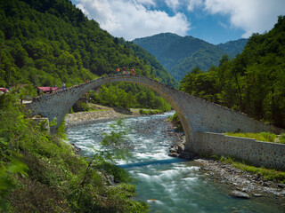 Fototapeta na wymiar Famous Senyuva ( Cinciva ) Stone bridge on the Firtina valley. Northern Turkey travel destination. long exposure shooting