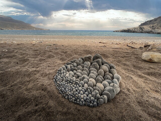 Stone sculpture on greece beach on crete island.