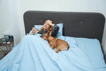 Ill female with fever resting in bedroom with her pet