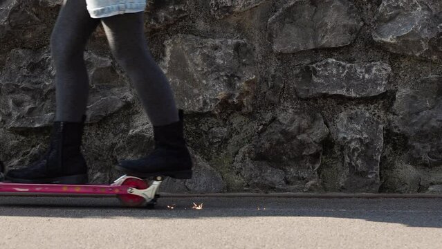 kid riding scooter that sparks when braking