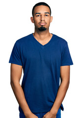 Fototapeta premium Young african american man wearing casual t shirt depressed and worry for distress, crying angry and afraid. sad expression.
