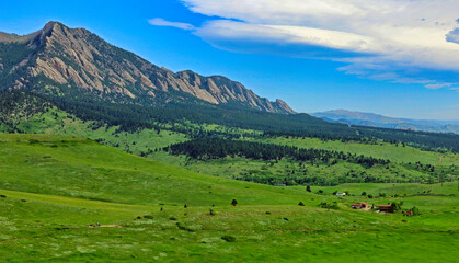 Fototapeta na wymiar The city of Boulder, Colorado, buys up undeveloped property and preserves it as protected open space for the public, like these acres of greenery near the Flatirons 