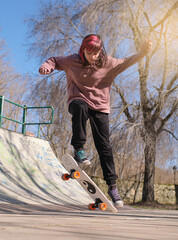 young girl doing a trick in a skate park © Christiangln