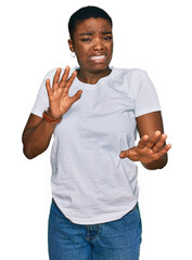 Young african american woman wearing casual white t shirt disgusted expression, displeased and...
