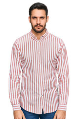 Fototapeta premium Young hispanic man wearing business shirt skeptic and nervous, frowning upset because of problem. negative person.