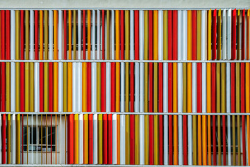 Colorful facade of rotating metal strips at a private school in Valencia, Spain