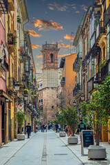 Fototapeta premium View of Carrer dels Serrans, with Torre de Sant Bartomeu in background, Valencia, Spain