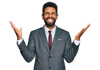 Young african american man wearing business clothes celebrating mad and crazy for success with arms raised and closed eyes screaming excited. winner concept