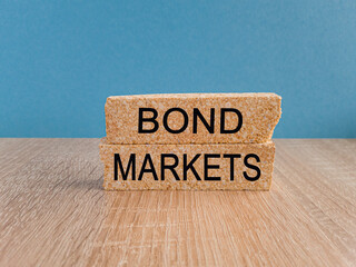 Bond markets symbol. Brick blocks with words 'Bond markets' on beautiful blue background, copy...