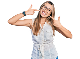 Hispanic young woman wearing casual white shirt smiling cheerful showing and pointing with fingers teeth and mouth. dental health concept.