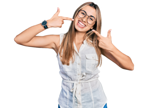 Hispanic young woman wearing casual white shirt smiling cheerful showing and pointing with fingers teeth and mouth. dental health concept.