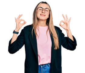 Hispanic young woman wearing business jacket and glasses relaxed and smiling with eyes closed doing meditation gesture with fingers. yoga concept.
