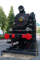 Fototapeta na wymiar Old steam locomotive near railway station in Ivano-Frankivsk, Ukraine