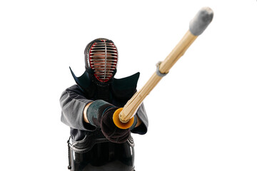 Fighter. Portrait of man, professional kendo athlete in uniform posing with shinai sword against...