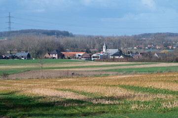 Fototapeta na wymiar View over the agriculture fields and the village of Kobbegem, Belgium