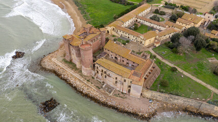 Fototapeta na wymiar Aerial view of the Castle of Santa Severa, located in Santa Marinella in Lazio, in the Metropolitan City of Rome, Italy. It is a medieval castle built on the beach and overlooking the Tyrrhenian Sea.