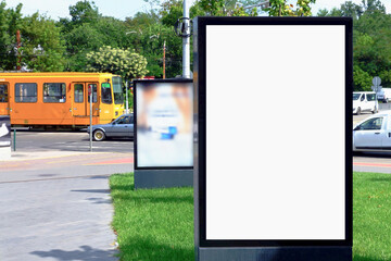 billboard and ad mockup lightbox. urban background with street traffic. blank white place holder. advertising background. glass and aluminum structure. urban scene. yellow streetcar.
