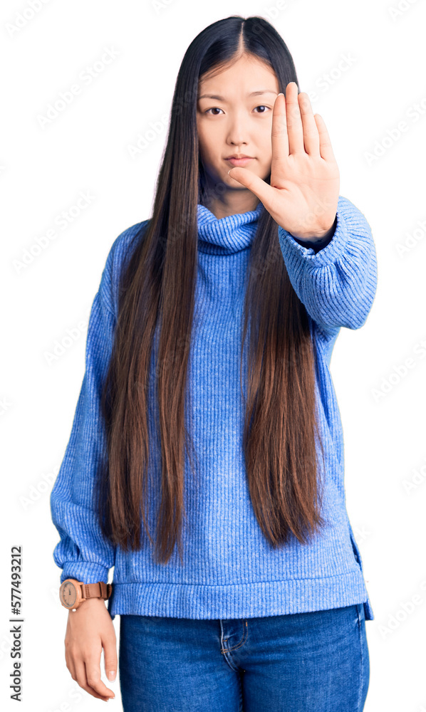 Sticker young beautiful chinese woman wearing casual turtleneck sweater doing stop sing with palm of the han