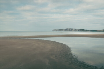 A beautiful sandy beach on an overcast day