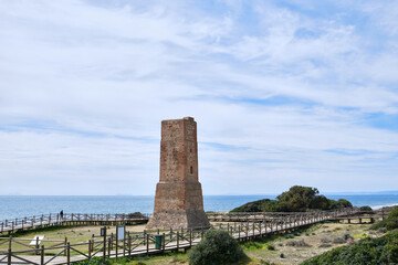 Old stone tower on Cabopino beach. Marbella coast. Province of Andalusia, Spain.
