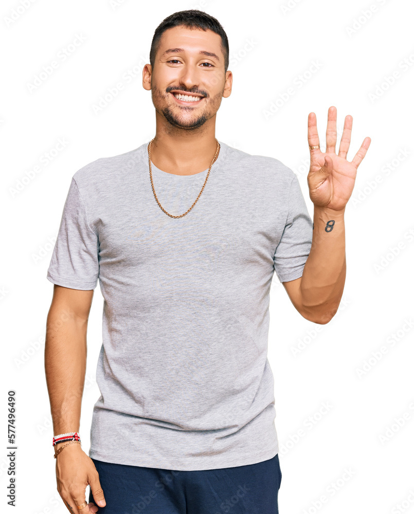 Wall mural handsome man with tattoos wearing 90s style showing and pointing up with fingers number four while s